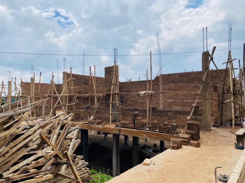 Brick walls going up at the new Bright School building, with wooden scaffolding