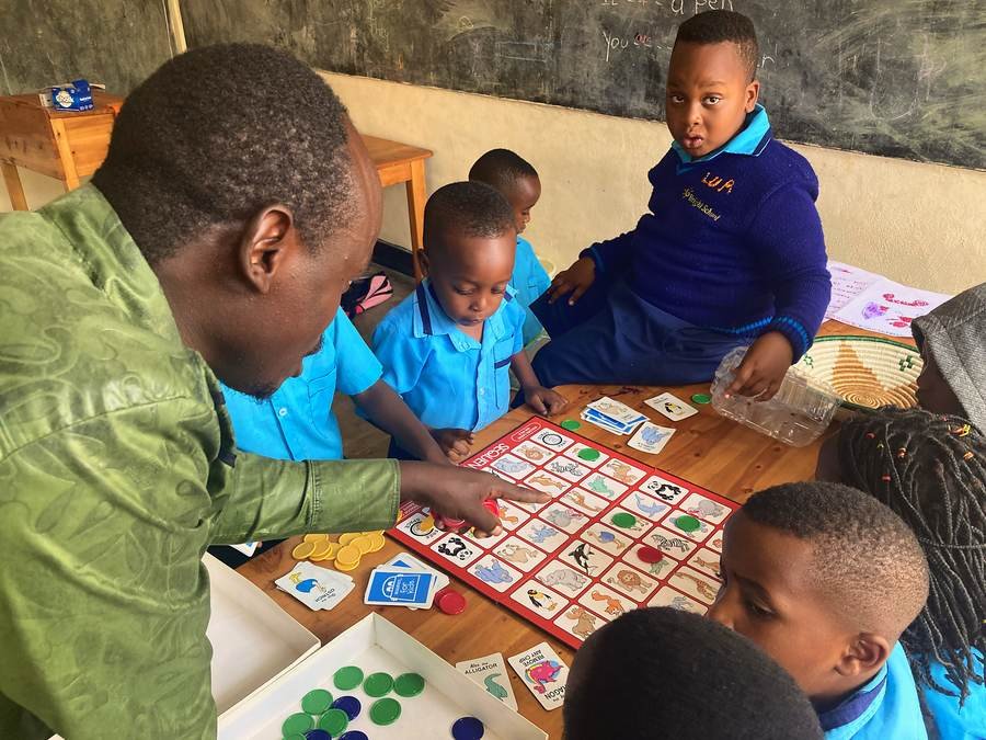 A teacher playing a learning game with a small group of children