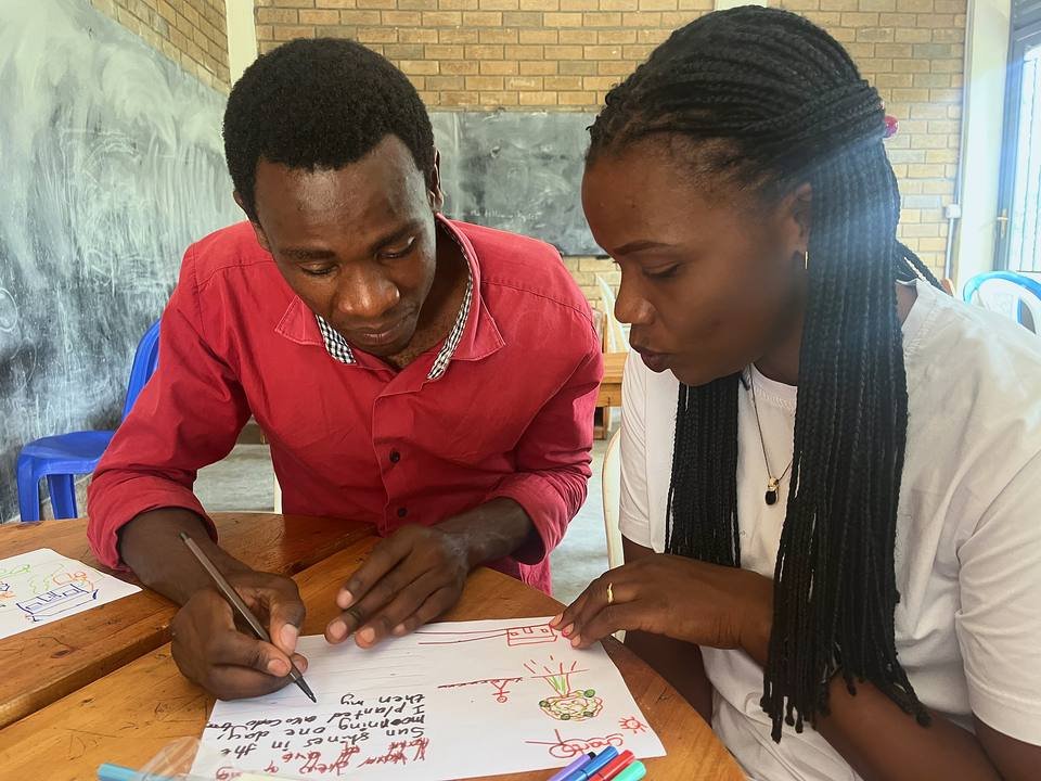 Two teachers planning a lesson together at a workshop