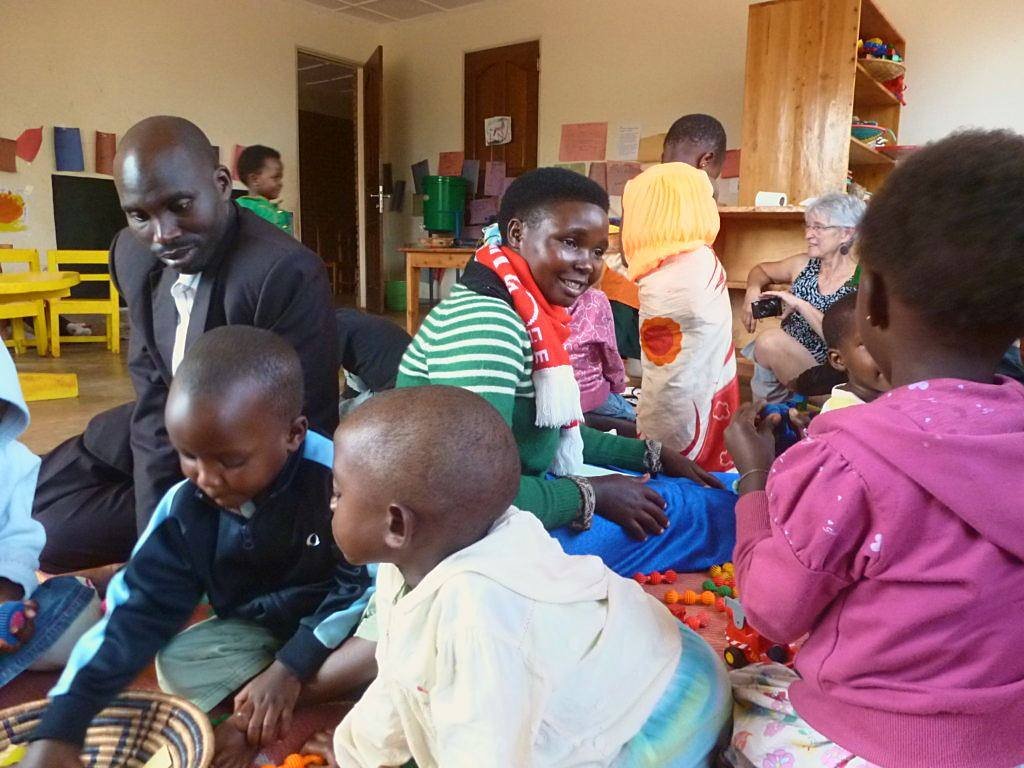 Learners and adults sitting together on the floor of a Harmony School classroom