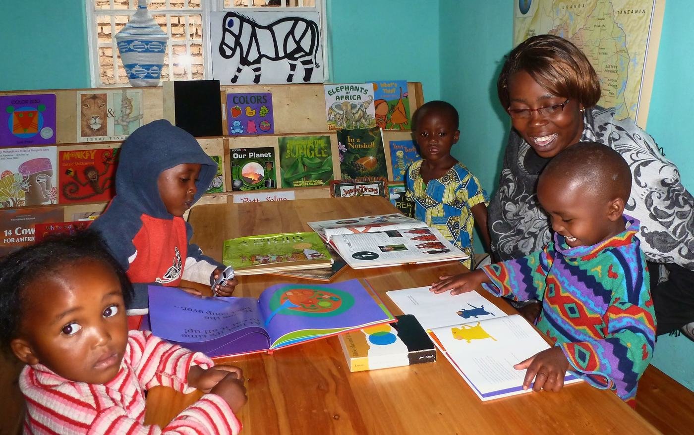Louise Batamuriza, who started Bright School in 2012, reading picture books with young children