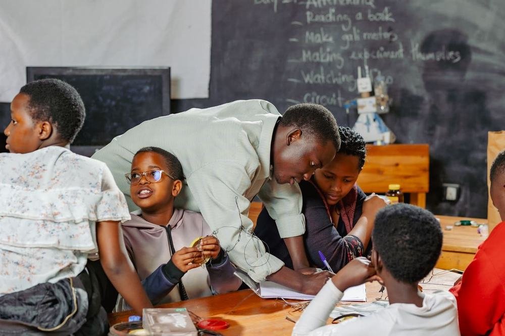 A TEACH Rwanda robotics team working together on a build