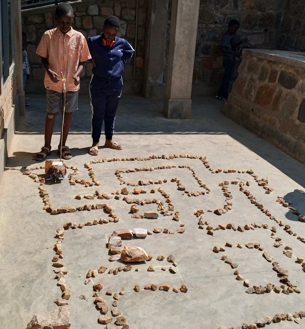 A student programming a robot through a maze challenge