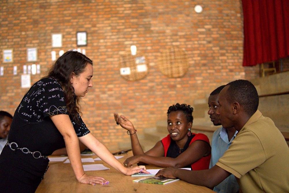 A T4T mentor coaching a group of teachers around a table