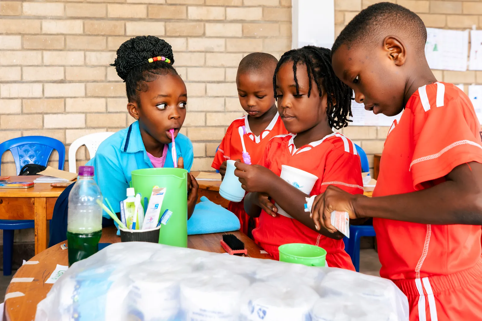 Children brushing their teeth together in a hygiene lesson