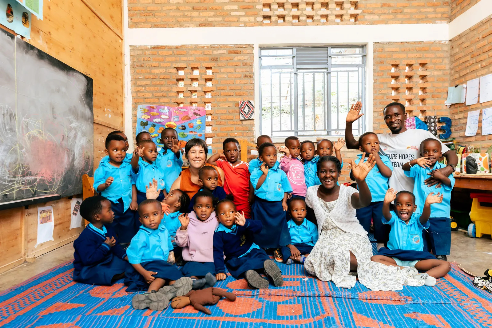 A Bright School class waving from their classroom in Muhanga