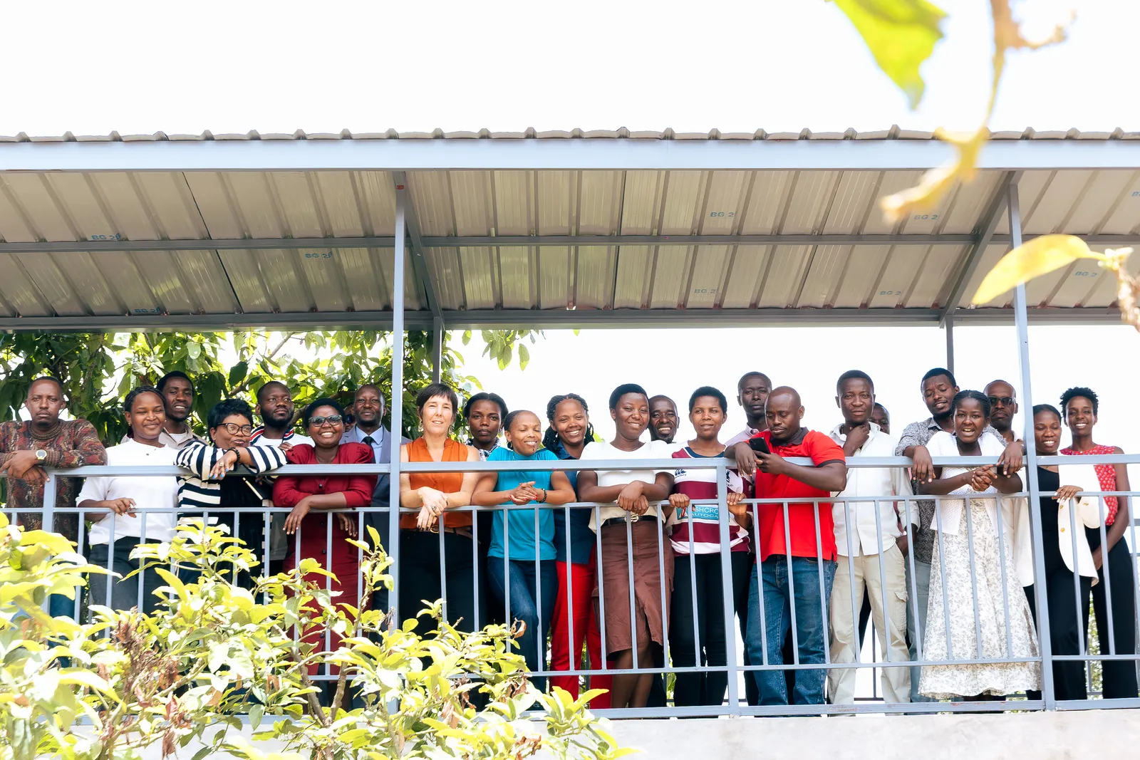 The whole Bright School community standing together on the covered veranda